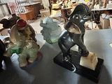 three figurines sitting on a table in a room