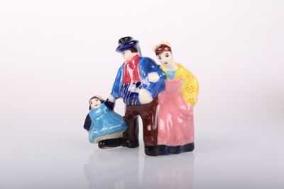 two figurines of people standing next to each other