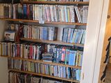 a book shelf full of books in the corner of a room