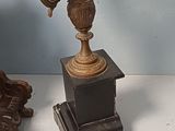 two antique candelabs sitting on a table next to each other
