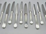 six knives and six knives on a table