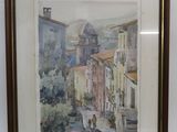 peinture aquarelle encadrée d'une scène de rue avec une église en arrière-plan