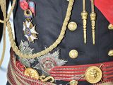 a man in a military uniform with a red sash