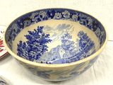 a blue and white bowl sitting on top of a table