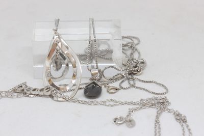 a necklace with a tear on it and a necklace with a tear on it