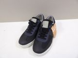 navy blue and orange sneakers with white soles on a white surface