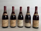 six bottles of wine lined up in a row on a table