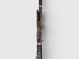 a close up of a black and gold flute on a white background