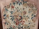 a chair with a floral tapestry on the back of it