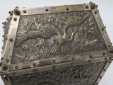 an antique silver box with a bird and flowers design on it