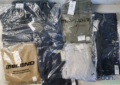 a lot of t - shirts that are wrapped in plastic