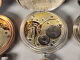many different types of pocket watches on display together
