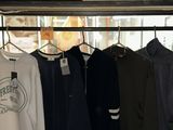 a lot of shirts hanging on a rack in a store