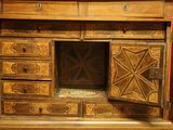a wooden cabinet with drawers and a door open