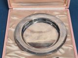 a silver plate with a spoon and a spoon in it