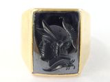 yellow gold ring with black onyxur of a dragon and rider