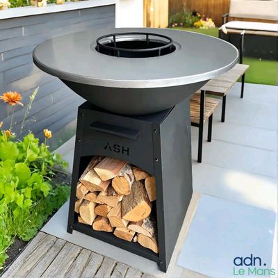 a fire pit sitting on a patio with a lot of wood