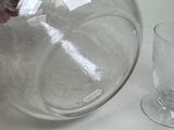 a person pouring something into a glass on the table