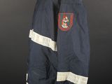 an old navy jacket with a red and white stripe on it