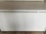 an image of a white refrigerator freezer sitting on top of a wooden floor