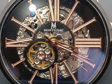 a close up of a watch with a black face