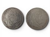 two silver coins with a woman ' s head and a man ' s head on them