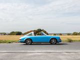 a blue car that is driving down the road