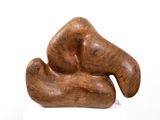 a wooden sculpture that is on a white surface