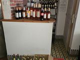 bottles of wine are lined up on a tiled floor in a room