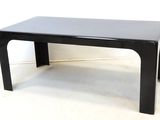 a black coffee table with a black top on a white floor