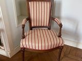 a chair in the corner of a room with a rug on the floor