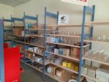many shelves with wine glasses on them in a store