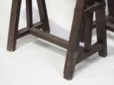 two wooden stools that are sitting next to each other
