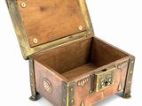 a small wooden chest with a metal latch on it