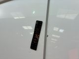 a remote control sitting on top of a white surfboard