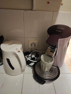 a coffee maker and a blender sitting on a kitchen counter