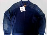 jacket with tag on it sitting on top of a white table