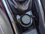 an image of a car ' s gear box with a clock on it