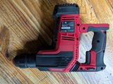 a close up of a corded drill on a wooden floor