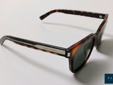 a pair of sunglasses sitting on a white surface