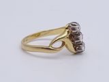 a close up of a gold ring with diamonds on a white background