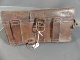 a brown leather case with two keys in it