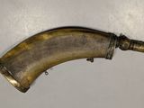 an old brass pipe on a table with a white background