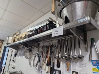 a large metal bucket on a shelf in a kitchen