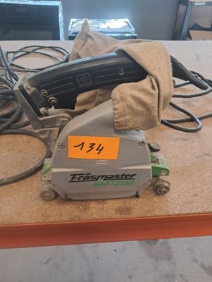 a picture of a table with a corded sander and a bag on it