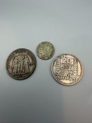 three different coins sitting on top of a table next to each other