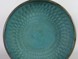 a blue plate that has a circular design on it