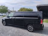 a picture of a black van parked in a parking lot