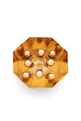 an image of a gold plate with pearls on it on a white background