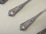 three spoons that are sitting on a table